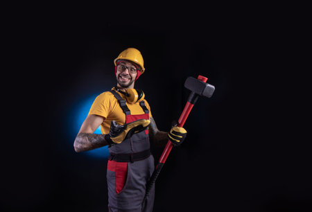 the male construction worker with a sledgehammer