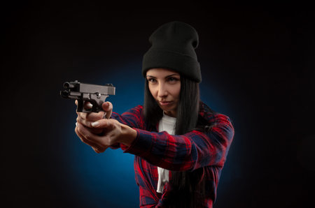 a girl in a checked shirt on a dark background with a gun