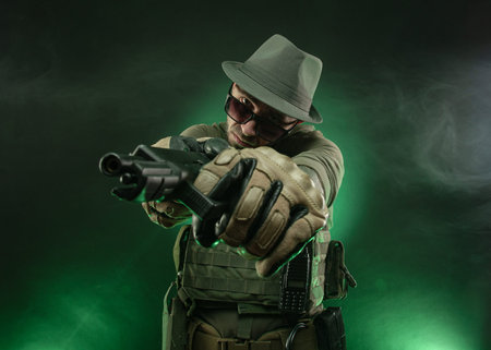 an athletic guy poses with a pistol