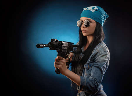 a girl in a DENIM jacket with an AUTOMATIC RIFLEの写真素材