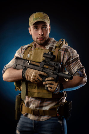 guys a military agent in a bulletproof vest with an automatic rifle