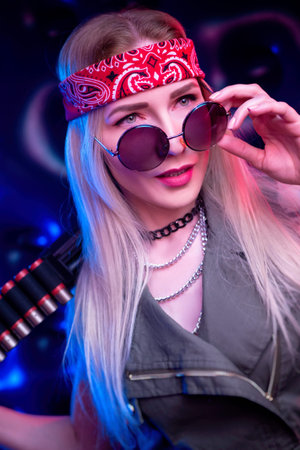 A girl who looks like a hippie with a shotgun in neon