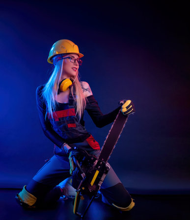 a girl with a chainsaw in overalls on a black background in a neon light