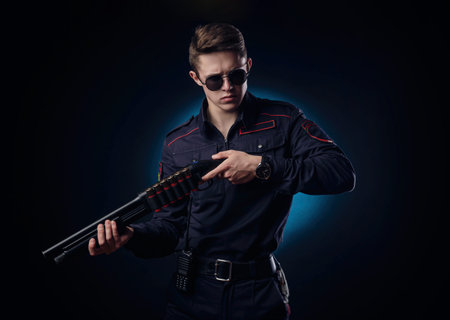 handsome guy in a police officers uniform with a gun