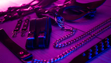 Set of erotic toys for BDSM. The game of sexual slavery with a whip, gag and leather blindfold. Intimate sex gamesの写真素材