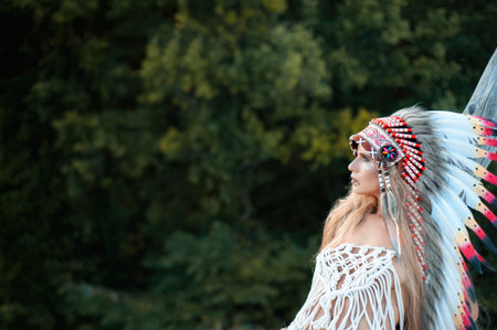 a woman in the image of the indigenous peoples of America posing in nature