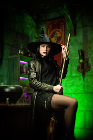 women in a hat in the witchs room on Halloween