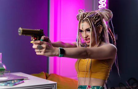 a young hooligan woman with dreadlocks in bright clothes with a gun expresses emotions in neon light