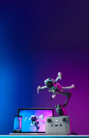 Belgorod Russia July 28, 2021, an unmanned aerial vehicle DJI Mini 2 with a remote control on the table stands on the stabilizer dji osmo mobile 3 with a laptop and a mobile phoneのeditorial素材