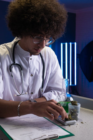 an Arab student with an Afro hairstyle in a doctors suit is engaged in cannabis research