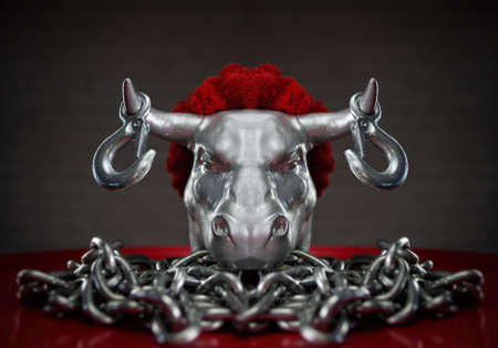 figurine of a bulls head with transportation hooks on horns and a metal chainの写真素材