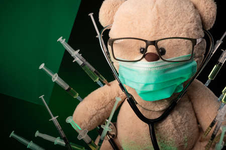 childrens vaccination against the virus and vaccinations on the example of a teddy bearの写真素材