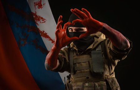 men in military uniform and balaclava with bloody hands show a heart with their own hands against the background of the bloody flag of Russiaの写真素材