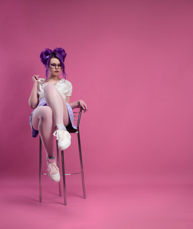 sexy girl with purple hair in summer clothes and beautiful underwear on a pink backgroundの写真素材