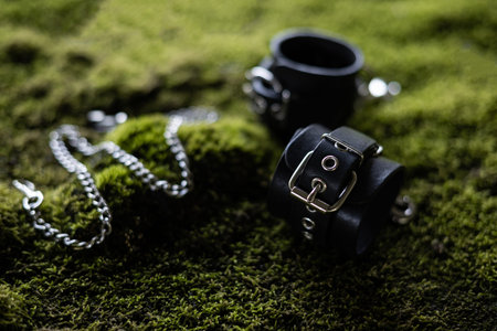 leather handcuffs for bdsm sex toys on green grass