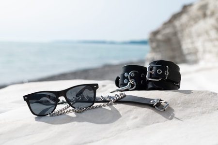 leather handcuffs for bdsm sex toys on the beach while on vacation in summer