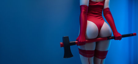 Sexy buttocks of a girl in a red bodysuit with an axe on a uniform blue background copypastの写真素材