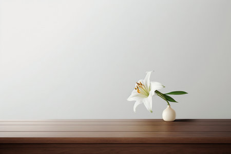 White lily flower in vase on wooden table and white wallの素材