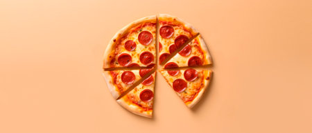Pepperoni pizza on an orange background. Top view with copy space.の素材
