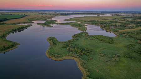 Aerial view of the river and forest at sunset in summer.の写真素材