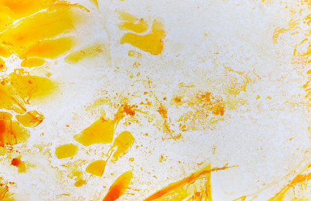 Abstract colorful yellow oil ink on paper close-up background texture