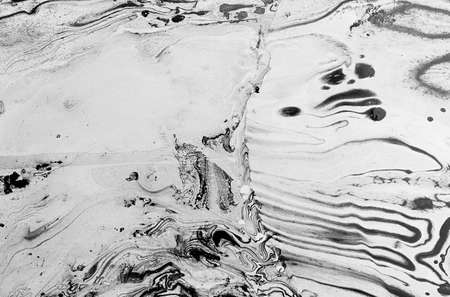 black Abstract colorful black oil ink on paper close-up background textureの写真素材