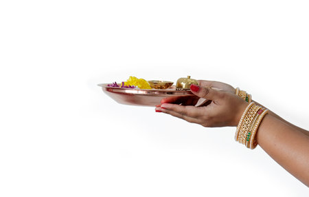 Pooja Thali woman hand holding decorated thali Decorated Pooja Thali for festivalの写真素材