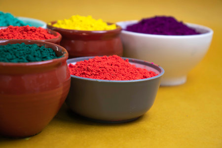 Indian festival Holi, Multi colors wooden bowl on dark backgroundの写真素材