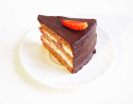 Piece of layered chocolate cake with strawberry sliceの写真素材