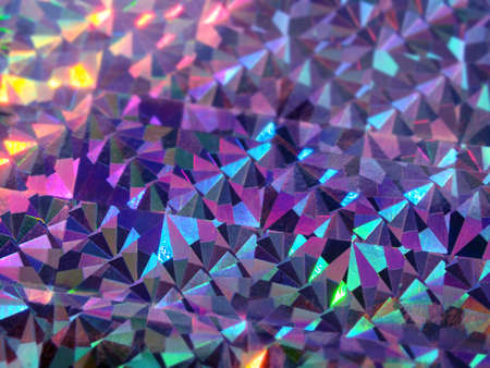 Holographic colorful dark violet lights festive background. Abstract geometric pattern backdrop. Design for your ad, poster, bannerの写真素材