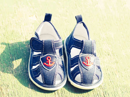 Blue cloth toddler sandals decorated with sea anchor. top viewの写真素材