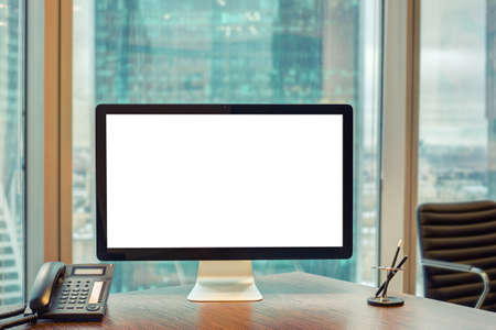 Computer with blank screen and telephone in the officeの写真素材