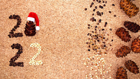 new year 2022 made of pine nuts on a cork background