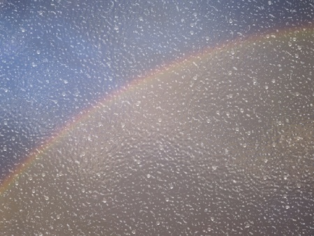 Rainy window texture and rainbow background.の写真素材