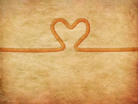 Yellow and grey rope heart on paper background.の写真素材