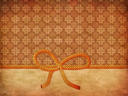 Yellow and grey rope bow on grunge decorative background.の写真素材