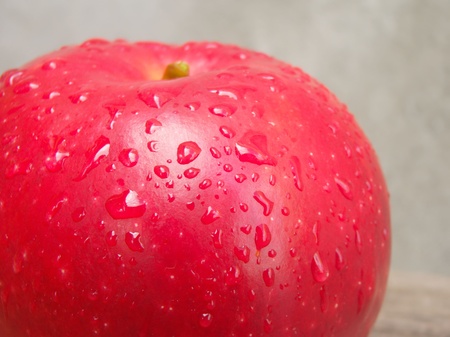 Close up view of red apple with water drops.の写真素材
