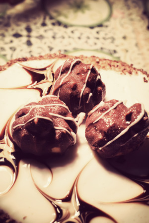Tasty chocolate cake with decorations, vintage photo effect.の写真素材