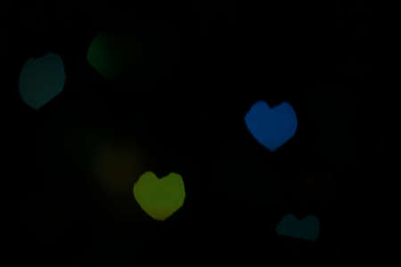 Bokeh in a shape of a heart texture, green and blue colors.の写真素材