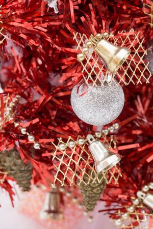 Small red Christmas tree on white snow background.の写真素材