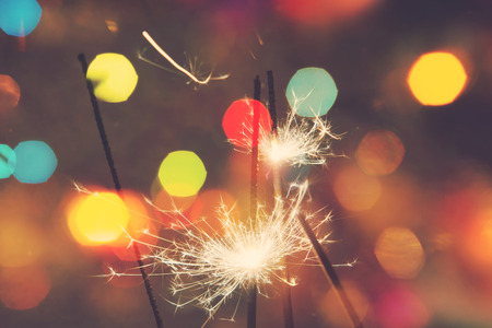 Bengal fire, sparkler and colorful bokeh christmas, new year background.の写真素材