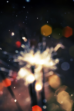 Bengal fire, sparkler and colorful bokeh with blurred snow, christmas, new year background.の写真素材