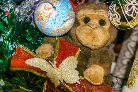 Brown monkey toy with decorated Christmas tree.の写真素材