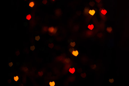 Bokeh in a shape of a heart texture, orange and red colors.