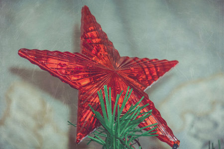 Holiday background with decorations on Christmas tree, vintage photo effect.