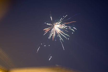 Photo of colorful fireworks against evening sky background.