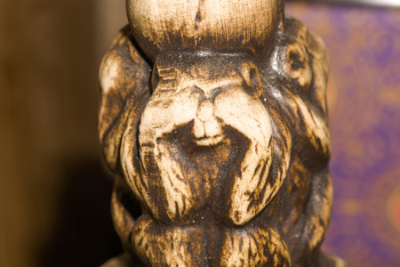 Macro of small wooden statuette of monkey.の写真素材