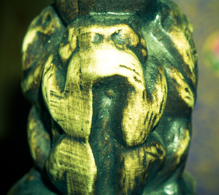 Macro of small wooden statuette of monkey, vintage photo effect.の写真素材