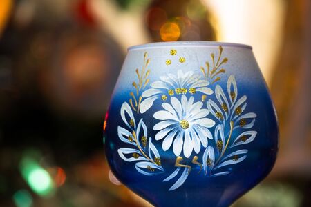 Decorative empty glass of blue color on colorful background.の写真素材