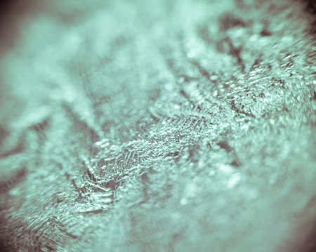 Extremely close up of natural frost patterns on glass.